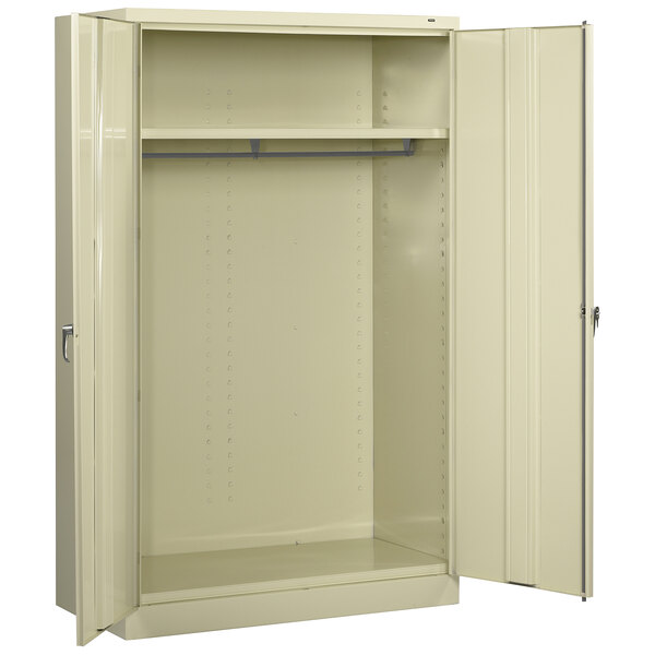 A putty metal Tennsco wardrobe cabinet with solid doors open.