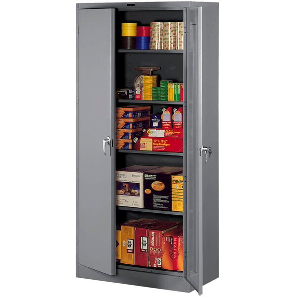 A dark gray Tennsco storage cabinet with shelves full of boxes.