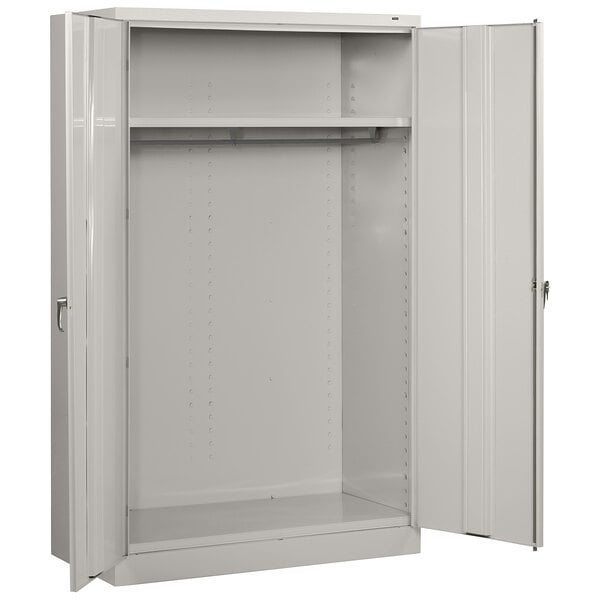 A light gray metal Tennsco jumbo wardrobe cabinet with open doors.