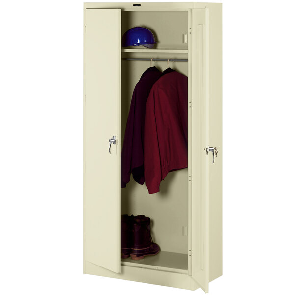 A putty metal Tennsco wardrobe cabinet with solid doors open to show a red shirt hanging inside.