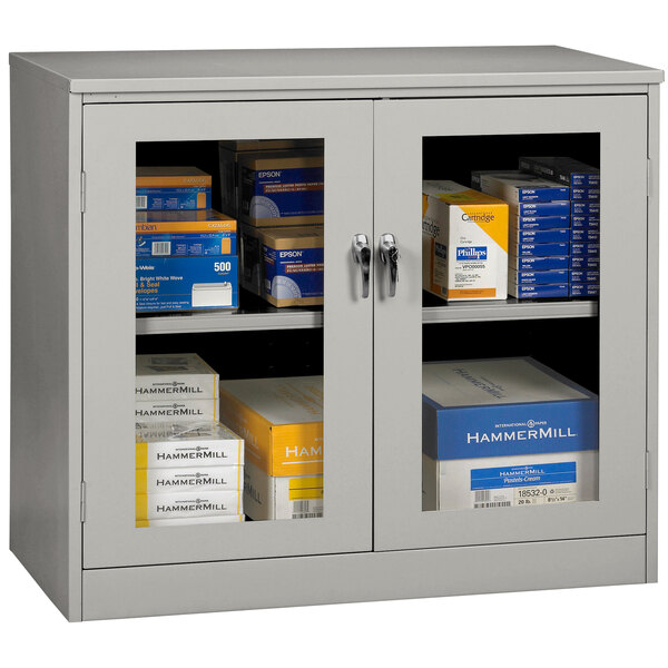 A light gray Tennsco storage cabinet with C-Thru doors.