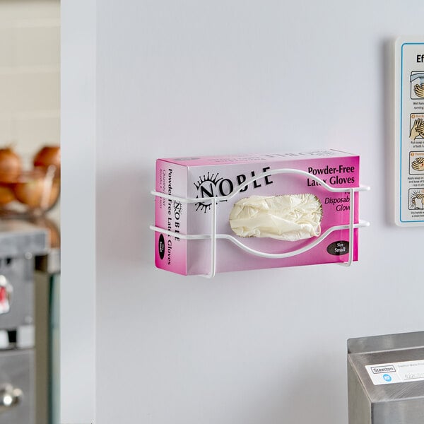 A single box wire wall mount glove dispenser holding a box of disposable gloves.