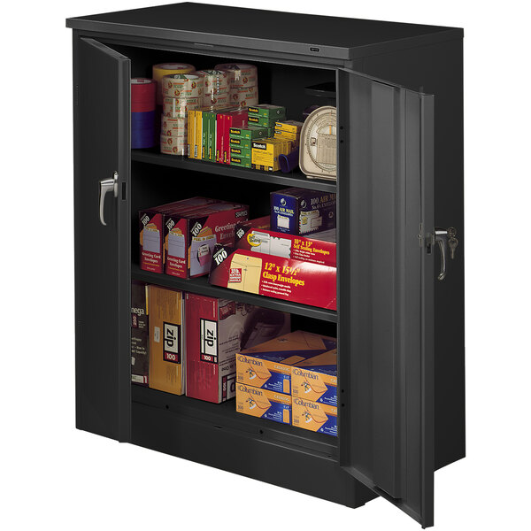 A black metal Tennsco storage cabinet with shelves full of boxes.