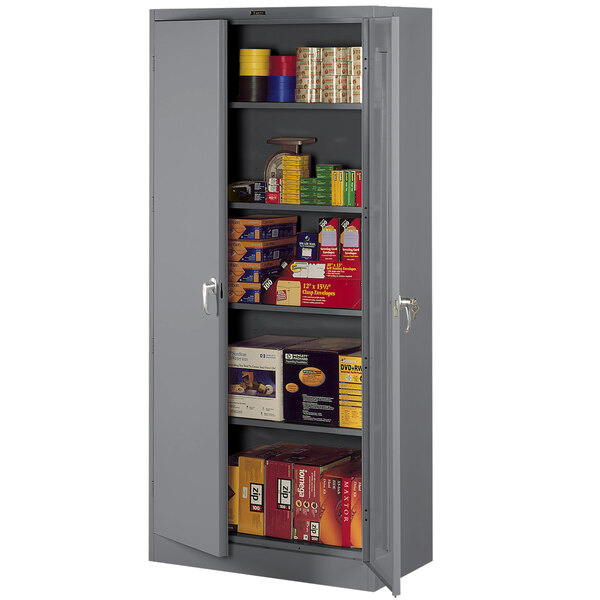 A grey metal Tennsco storage cabinet with solid doors and shelves.