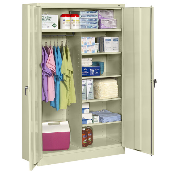A Tennsco putty jumbo combination cabinet with solid doors filled with items on the shelves.