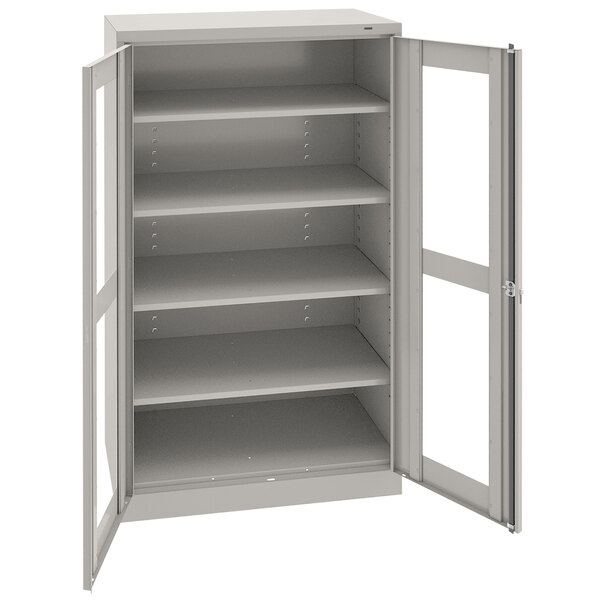 A light gray metal Tennsco storage cabinet with open doors.