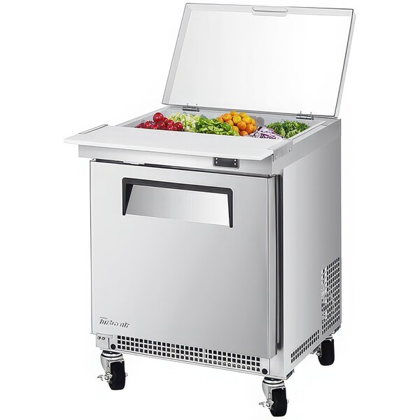 A Turbo Air stainless steel refrigerated salad prep table with a clear lid.