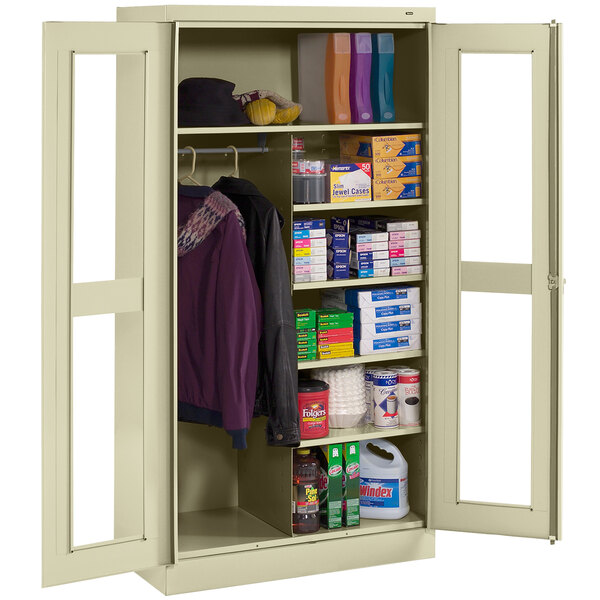 A Tennsco putty metal standard combination cabinet with C-Thru doors with several items inside.