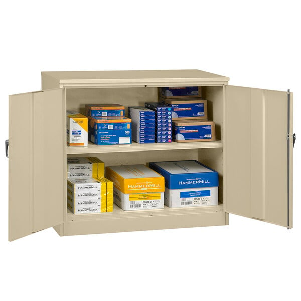 A sand Tennsco jumbo storage cabinet with solid doors and white text on a yellow box.