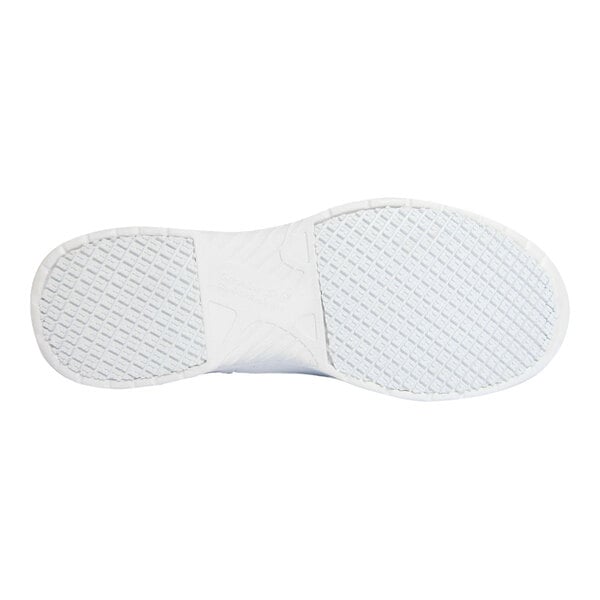 The image shows the white, textured sole of a shoe with a grid-like tread pattern.