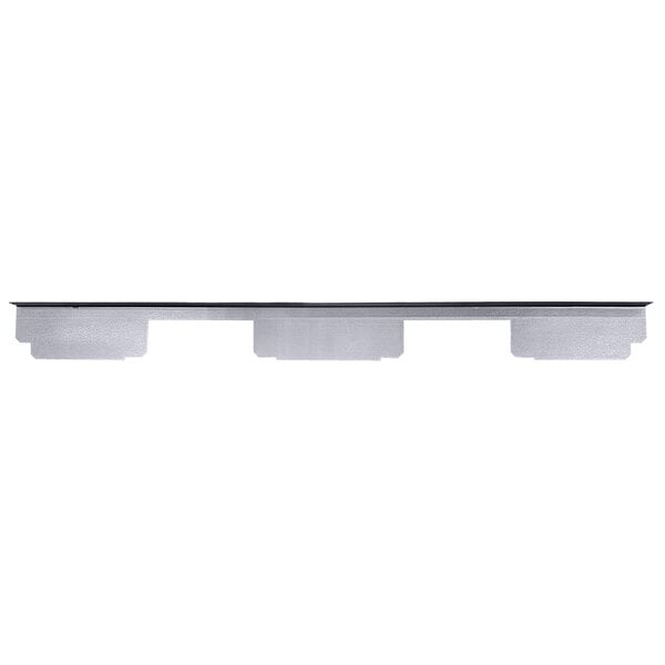 A white shelf with three rectangular holes.