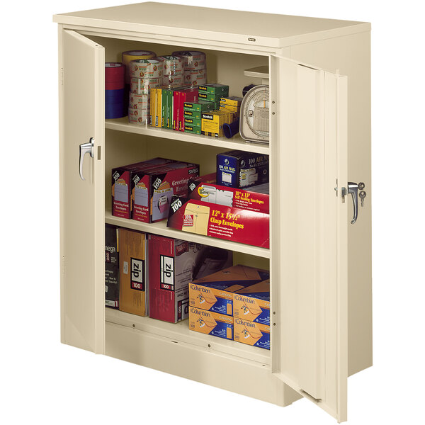 A white Tennsco storage cabinet with shelves full of boxes and cans.