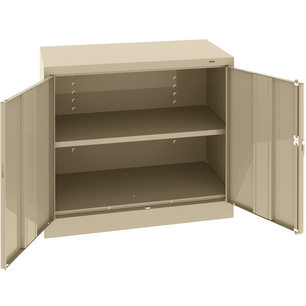 A tan Tennsco storage cabinet with solid doors.