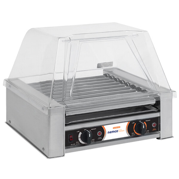 A Nemco hot dog roller grill on a counter with a clear cover.