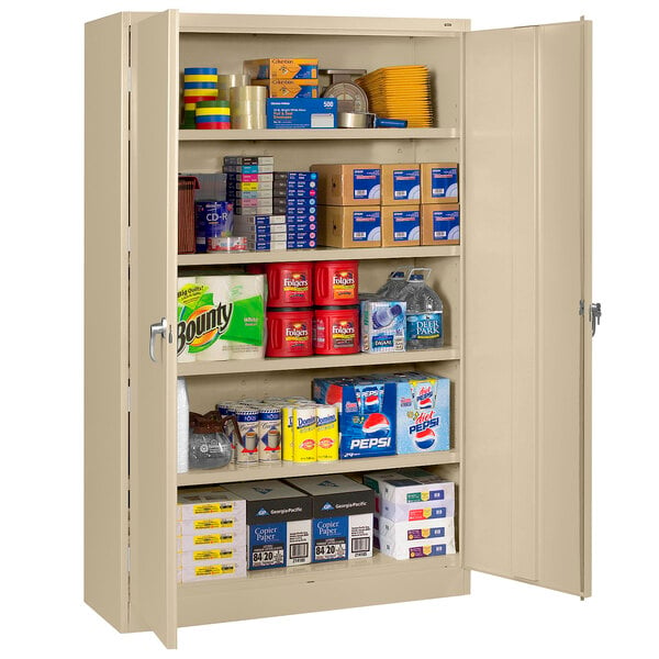 A Tennsco sand jumbo storage cabinet with solid doors filled with items.