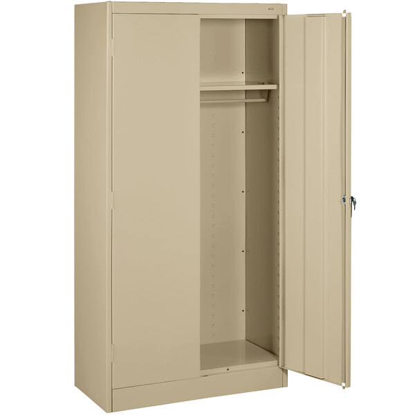 A tan metal Tennsco wardrobe cabinet with solid doors open.