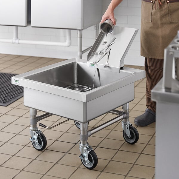 A stainless steel Regency sink with silverware in it.