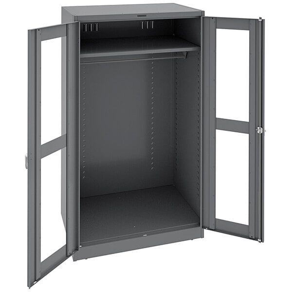 A dark gray metal Tennsco wardrobe cabinet with open doors.