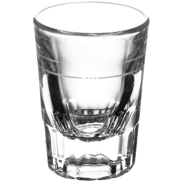 A clear Libbey fluted shot glass with a thin line near the bottom.