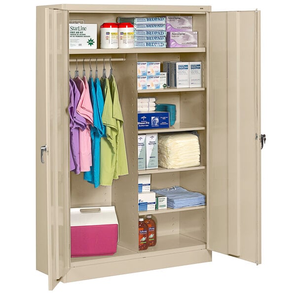 A Tennsco sand jumbo combination cabinet with solid doors filled with items on the shelves.