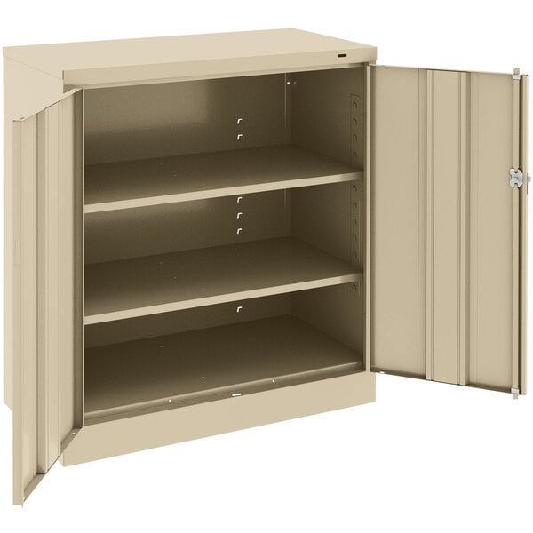 A beige Tennsco metal storage cabinet with open doors.