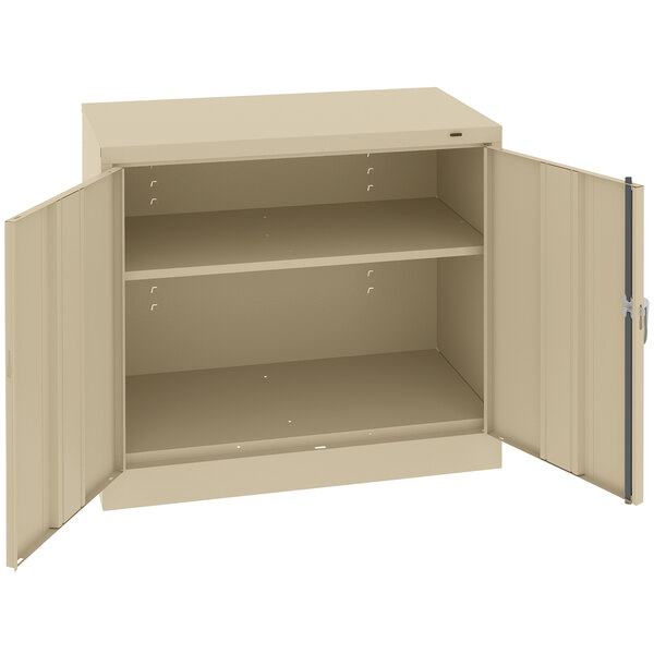 A tan Tennsco storage cabinet with open solid doors.