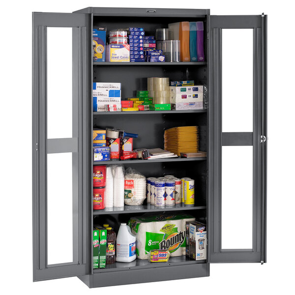 A large metal Tennsco storage cabinet with shelves full of products.