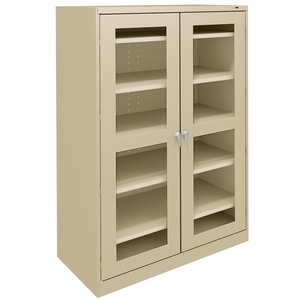 A sand Tennsco storage cabinet with C-Thru doors.