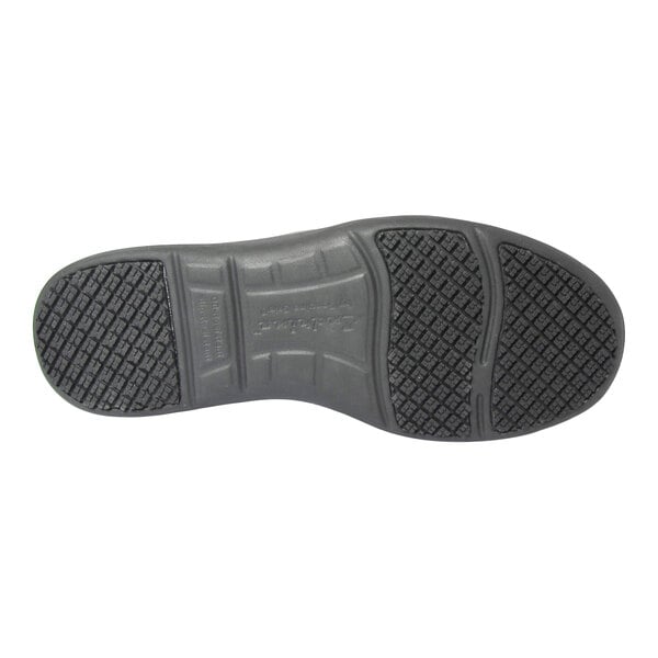 The image shows the black rubber sole of a shoe with a textured, non-slip tread pattern.