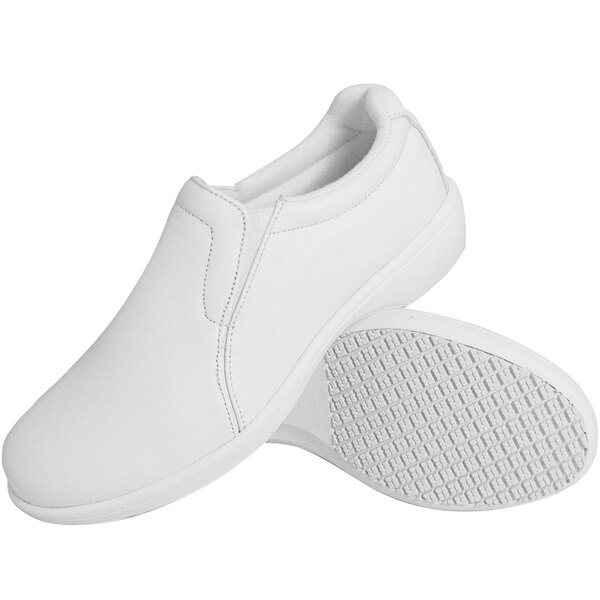 A pair of plain white slip-on shoes with textured non-slip soles, shown from a side and bottom view.
