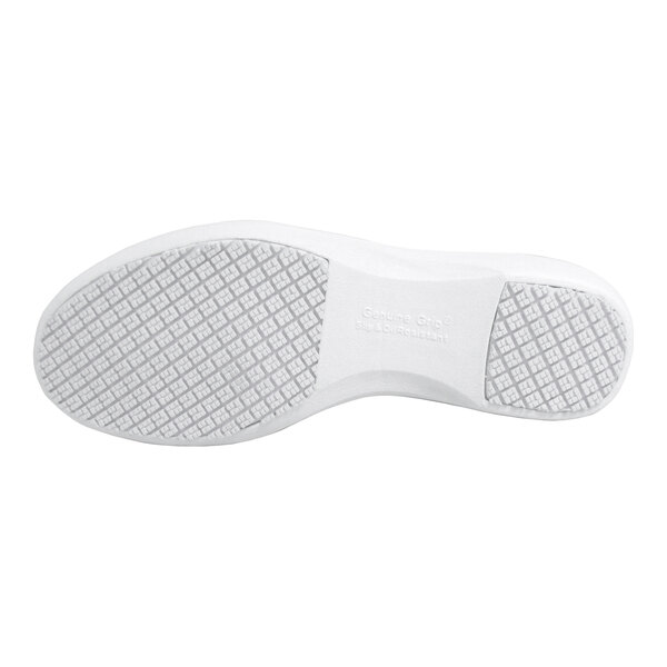 The image shows the white, textured sole of a shoe with a grid-like tread pattern.