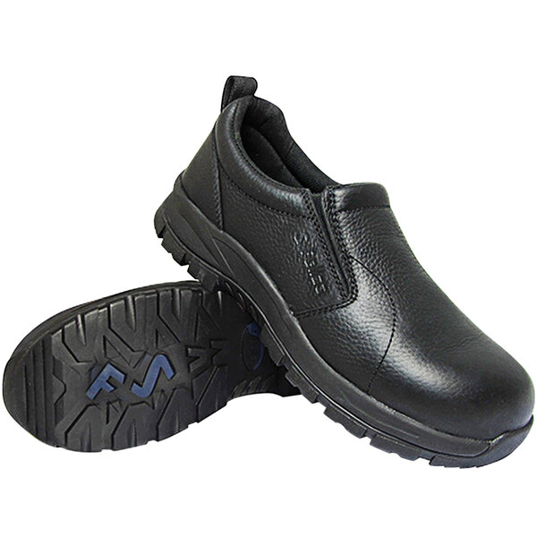 A pair of black slip-on shoes with textured soles, one shoe standing upright and the other lying on its side to display the sole.