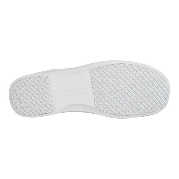 The image shows the white, textured sole of a shoe with a non-slip pattern.