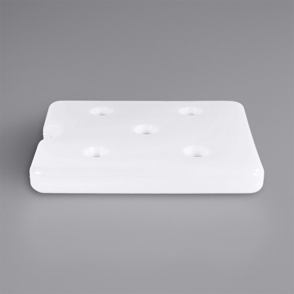 A white rectangular cooling cell with holes in it.