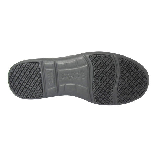 The image shows the black rubber sole of a shoe with a textured, non-slip tread pattern.