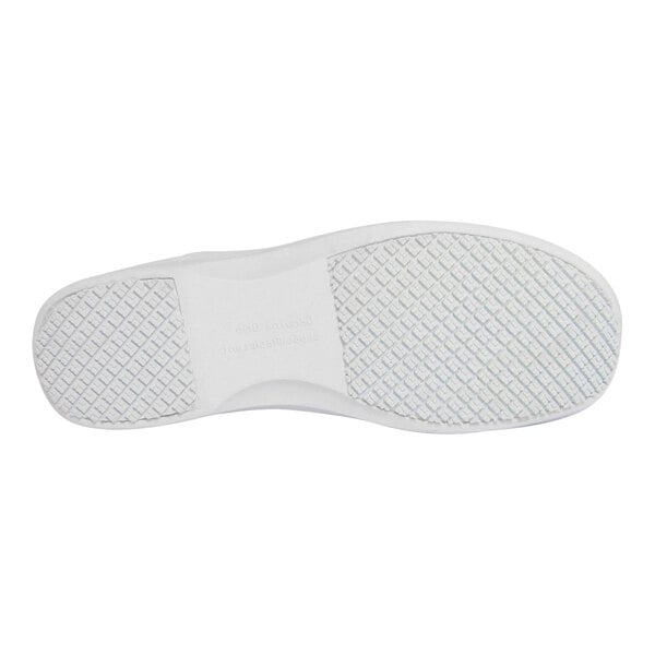 The image shows the white, textured sole of a shoe with a non-slip pattern.