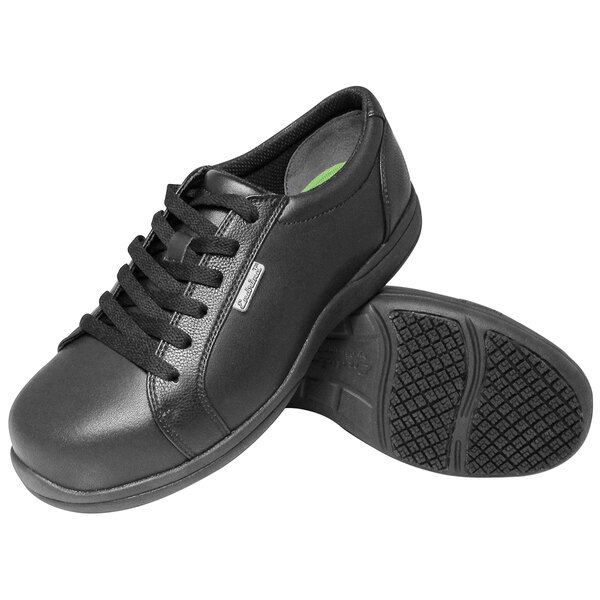A pair of black lace-up oxford shoes with a textured non-slip sole, shown from a side and bottom view.