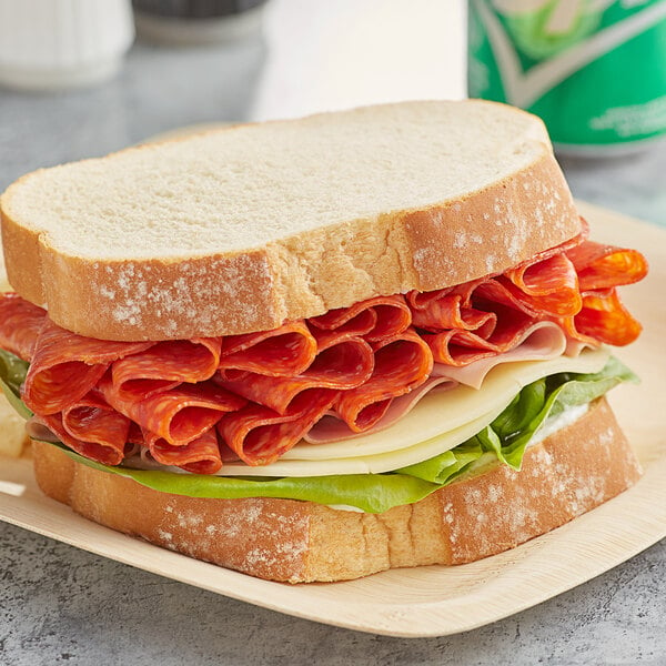 A sandwich on a plate with Hormel pepperoni and cheese.