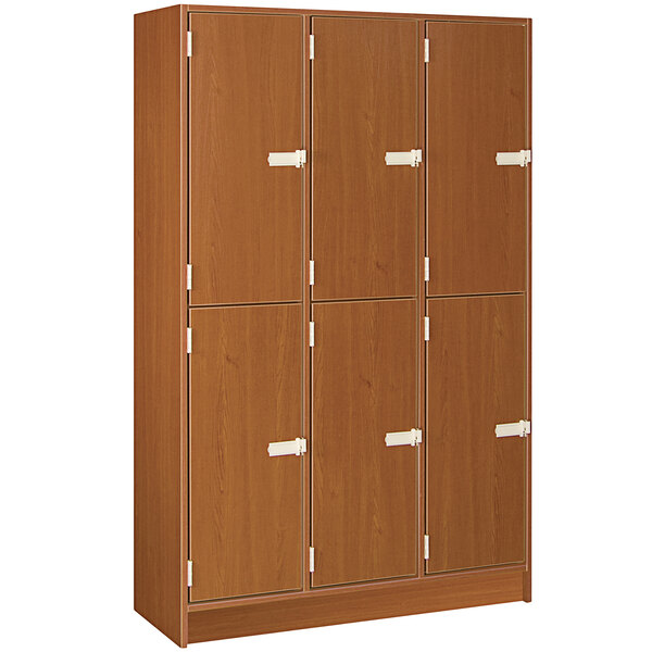 A wooden locker with three doors and a middle shelf.