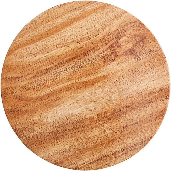 An Enjay round wood cake board with a marble and wood surface.