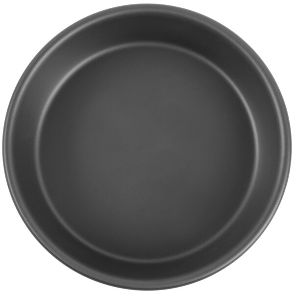 A black round pan with a white background.