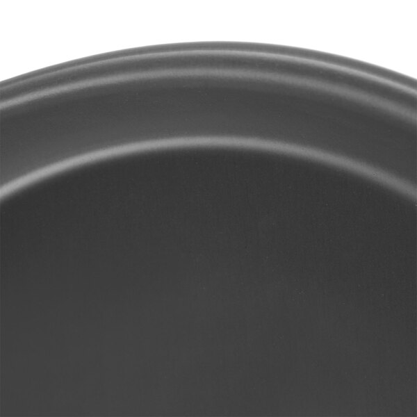 A close-up of a Chicago Metallic Deep Dish Pizza Pan.