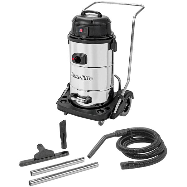 A Powr-Flite wet/dry vacuum with hoses and accessories on a table.