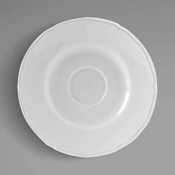 A Tuxton bright white saucer with a scalloped edge.