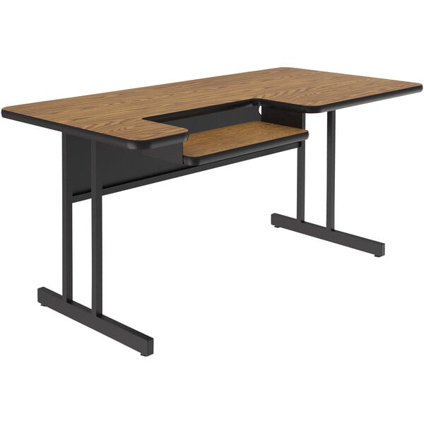 A Correll computer and training desk with a medium oak top and black base.