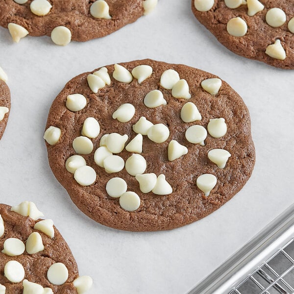 A chocolate chip cookie with HERSHEY'S Premier White Creme Baking Chips on top.