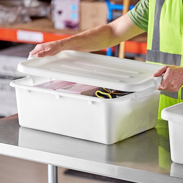 A man opening a white Lavex plastic container with a lid.