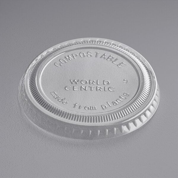 A close-up of a clear World Centric plastic lid with text.
