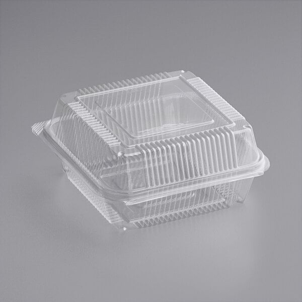 A World Centric clear compostable PLA hinged clamshell container with a lid.