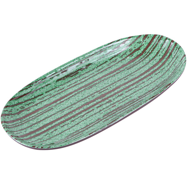 An oval white melamine plate with a glossy green and brown swirl pattern.